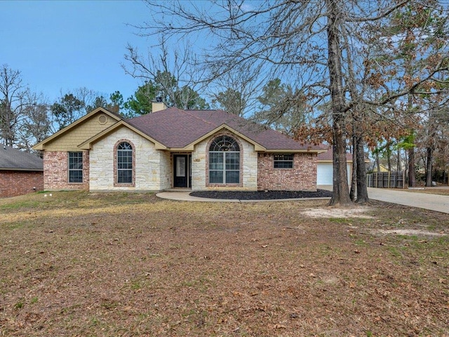 view of front of property with a garage and a front lawn