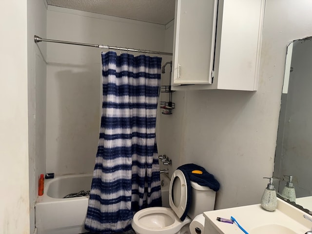 full bathroom featuring shower / bath combination with curtain, toilet, a textured ceiling, and vanity