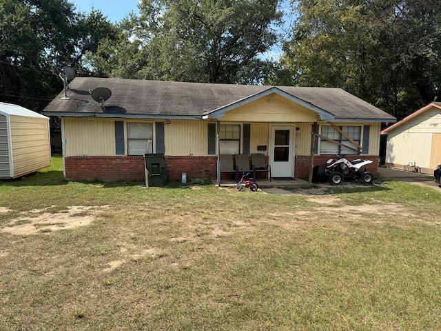 view of front of home featuring covered porch and a front yard