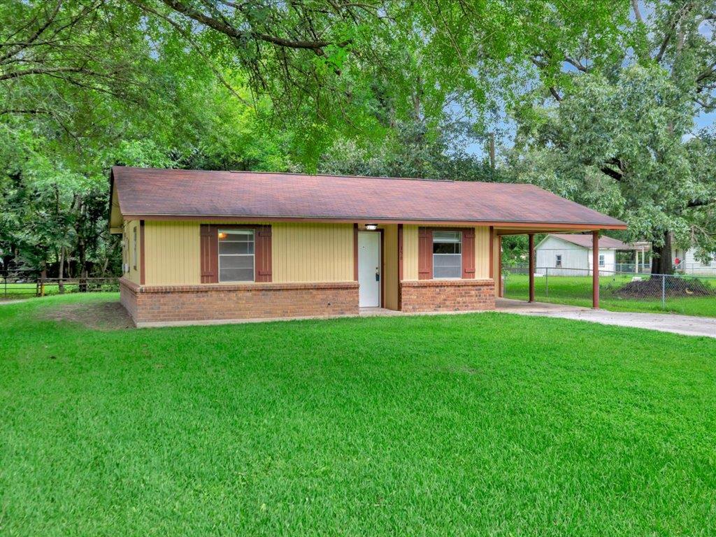 156 Spain Rd, Lufkin, TX 75901 - single story home featuring brick siding, an attached carport, concrete driveway, and roof with shingles