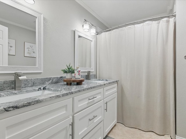 bathroom with double vanity, ornamental molding, and a sink