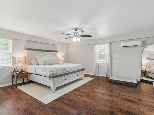 bedroom featuring a wall mounted air conditioner, arched walkways, wood finished floors, and baseboards