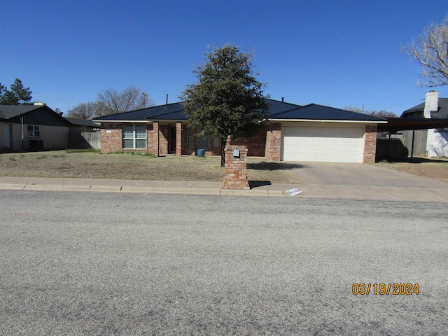 ranch-style house with solar panels and a garage