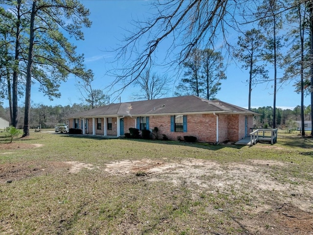 ranch-style home with a front lawn and brick siding