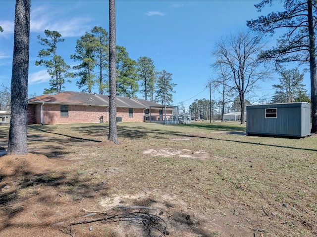 view of yard with an outbuilding and a shed