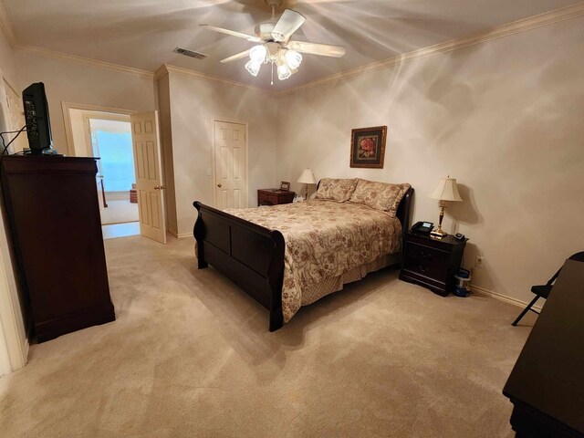 carpeted bedroom featuring ceiling fan and ornamental molding