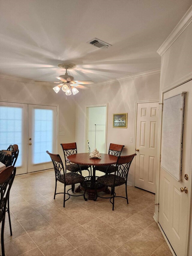 tiled dining area featuring ceiling fan, french doors, and ornamental molding