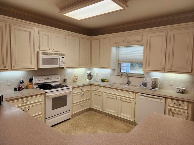 kitchen with crown molding, sink, light tile patterned flooring, and white appliances