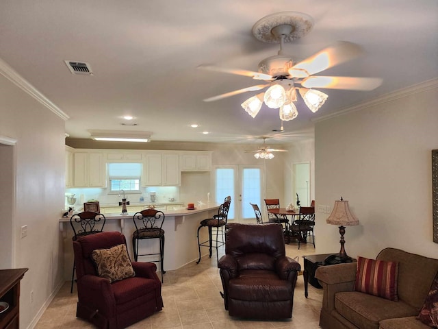 living room with a healthy amount of sunlight, ceiling fan, and ornamental molding