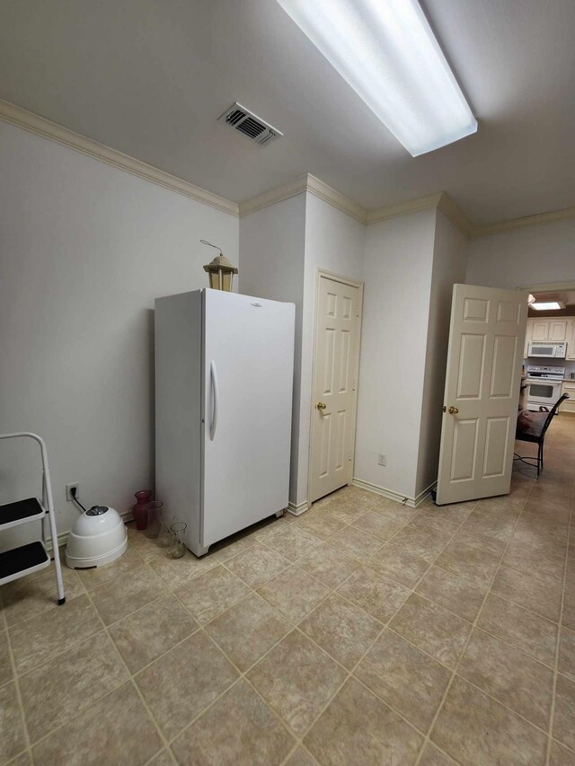 washroom with ornamental molding and light tile patterned floors