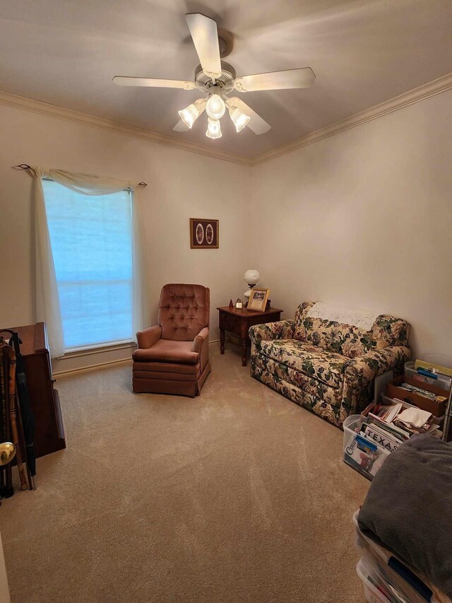 carpeted living room featuring ceiling fan and ornamental molding