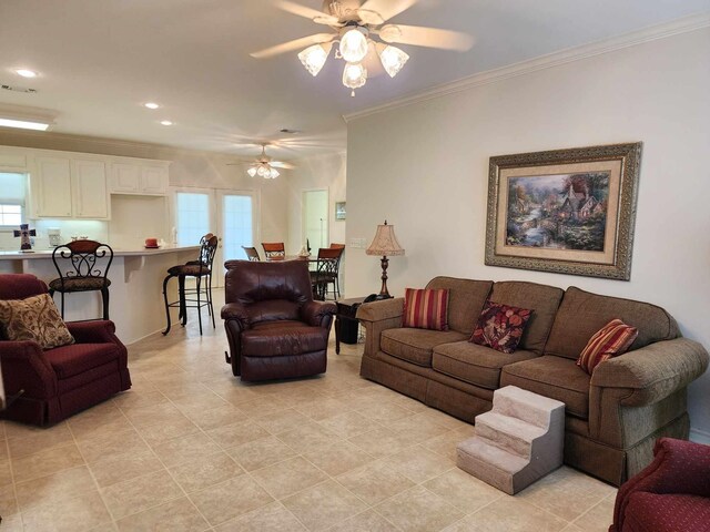 living room with ceiling fan, light tile patterned floors, and ornamental molding