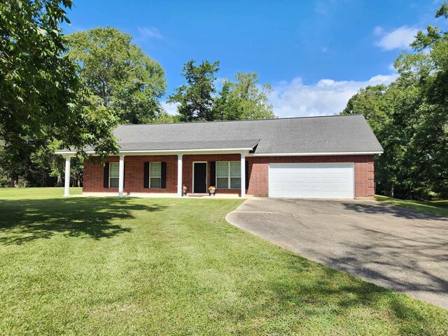 ranch-style house featuring a garage and a front lawn