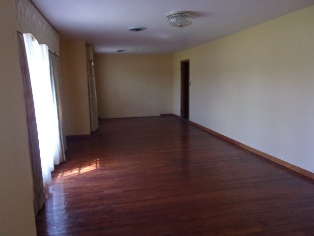 corridor featuring dark hardwood / wood-style floors