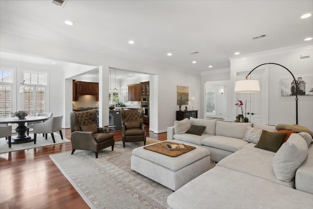 living room featuring hardwood / wood-style floors and ornamental molding