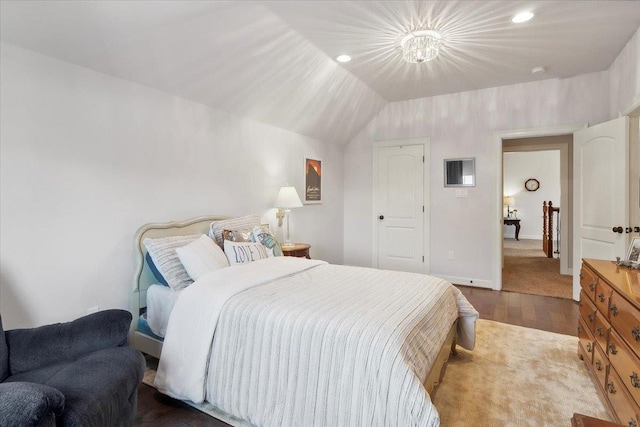 bedroom with light hardwood / wood-style floors and vaulted ceiling