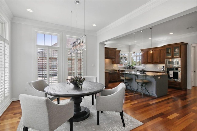 dining room with crown molding and dark hardwood / wood-style floors