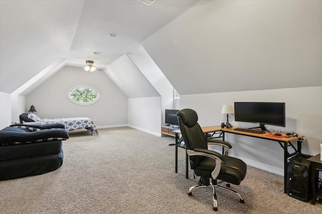 carpeted home office with vaulted ceiling