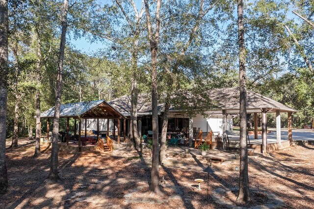 back of house featuring a gazebo