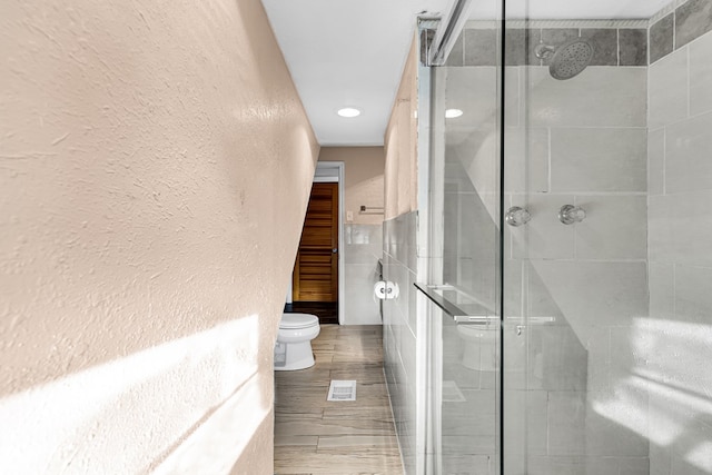 bathroom with walk in shower and toilet