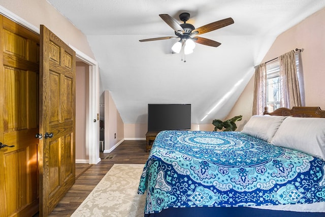 bedroom featuring ceiling fan, lofted ceiling, a textured ceiling, and dark hardwood / wood-style flooring