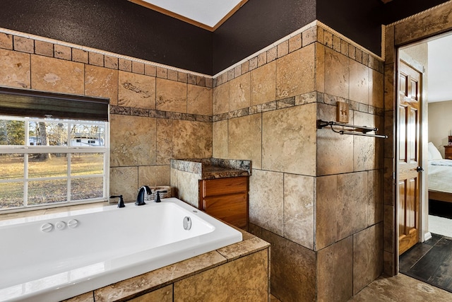 bathroom featuring tiled tub