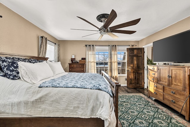 bedroom with ceiling fan and dark hardwood / wood-style flooring