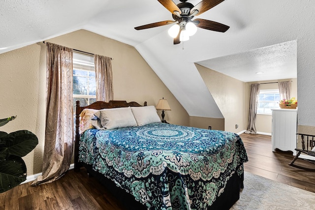 bedroom featuring vaulted ceiling, ceiling fan, hardwood / wood-style floors, and a textured ceiling