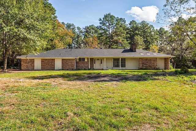 ranch-style home featuring a front lawn, brick siding, and a chimney