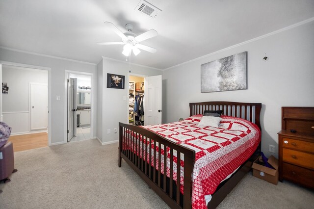 1514 Spanish Moss Dr, Lufkin, TX 75904 - bedroom with carpet, a walk in closet, ornamental molding, a closet, and ensuite bathroom