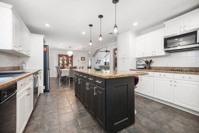 1514 Spanish Moss Dr, Lufkin, TX 75904 - kitchen with stainless steel appliances, white cabinets, backsplash, recessed lighting, and dark cabinets