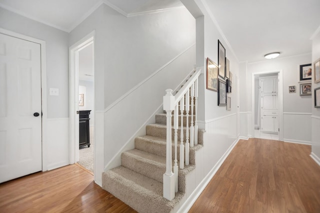 1514 Spanish Moss Dr, Lufkin, TX 75904 - stairs with wood finished floors, ornamental molding, and wainscoting