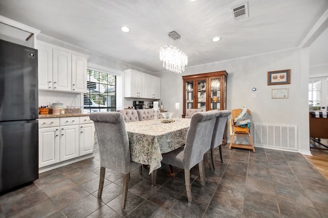 1514 Spanish Moss Dr, Lufkin, TX 75904 - dining area with a chandelier, recessed lighting, baseboards, crown molding, and dark stone finish floors