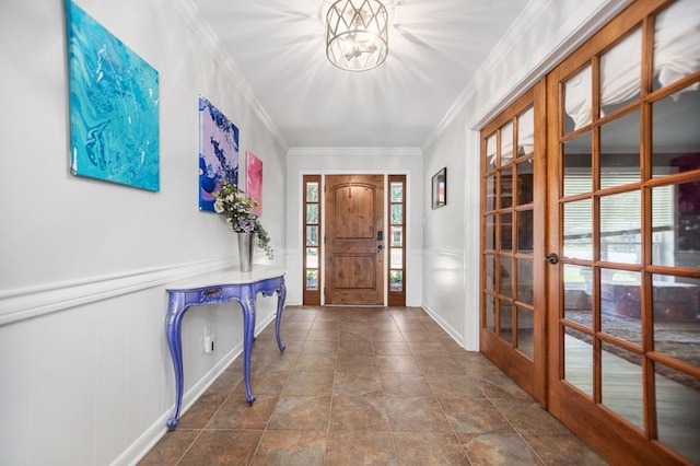 1514 Spanish Moss Dr, Lufkin, TX 75904 - entrance foyer featuring a decorative wall, french doors, crown molding, wainscoting, and stone finish flooring