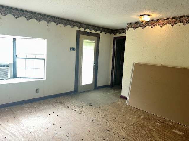 unfurnished room featuring a textured ceiling