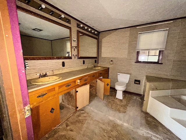 bathroom featuring a sink, toilet, a textured ceiling, concrete flooring, and double vanity