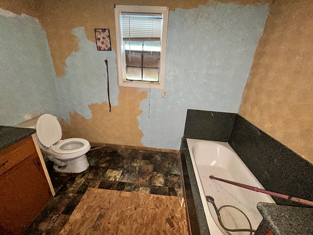 full bathroom featuring a bath and toilet