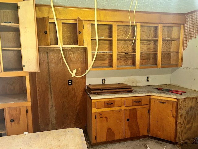 kitchen with brown cabinetry and light countertops