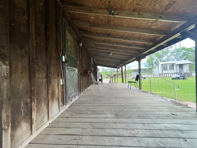 wooden terrace featuring a lawn