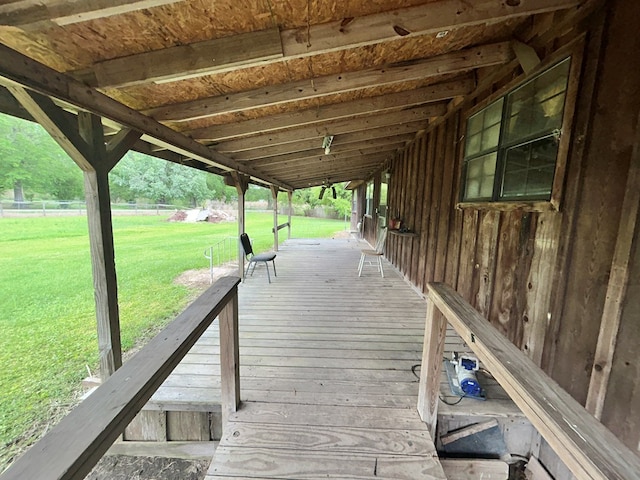 wooden terrace with a yard