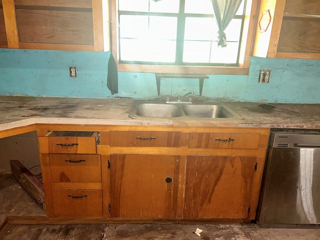 kitchen featuring a sink, light countertops, brown cabinetry, and dishwasher