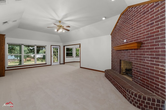 806 Cartwright, San Augustine, TX 75972 - living room with vaulted ceiling, light colored carpet, ceiling fan, baseboards, and a brick fireplace