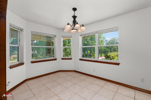 806 Cartwright, San Augustine, TX 75972 - unfurnished room featuring plenty of natural light, a chandelier, and baseboards