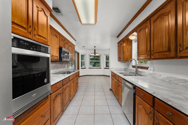 806 Cartwright, San Augustine, TX 75972 - kitchen with a sink, stainless steel appliances, decorative backsplash, light countertops, and brown cabinetry