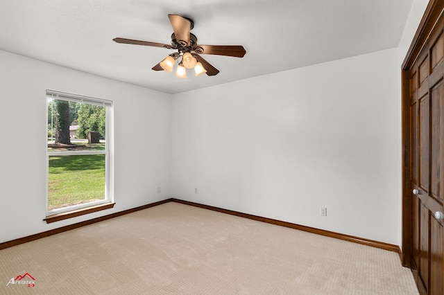 806 Cartwright, San Augustine, TX 75972 - empty room featuring light colored carpet, ceiling fan, and baseboards