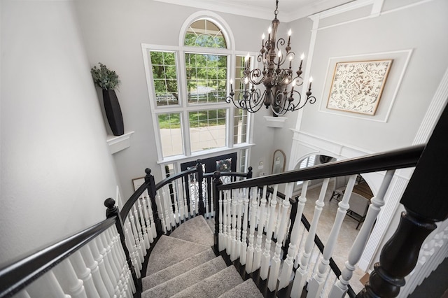 486 Brookwood Dr, Diboll, TX 75941 - stairs with crown molding, a towering ceiling, and a notable chandelier