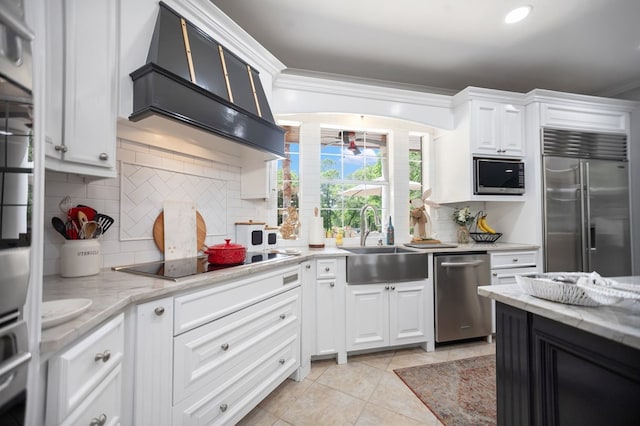 486 Brookwood Dr, Diboll, TX 75941 - kitchen with a sink, built in appliances, backsplash, and white cabinetry
