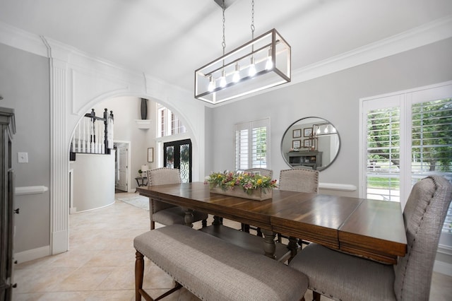 486 Brookwood Dr, Diboll, TX 75941 - dining space featuring arched walkways, baseboards, ornamental molding, and light tile patterned floors