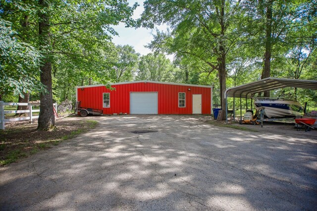 486 Brookwood Dr, Diboll, TX 75941 - garage featuring fence, a detached carport, and driveway