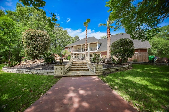 486 Brookwood Dr, Diboll, TX 75941 - back of house with stairs, a yard, and a balcony